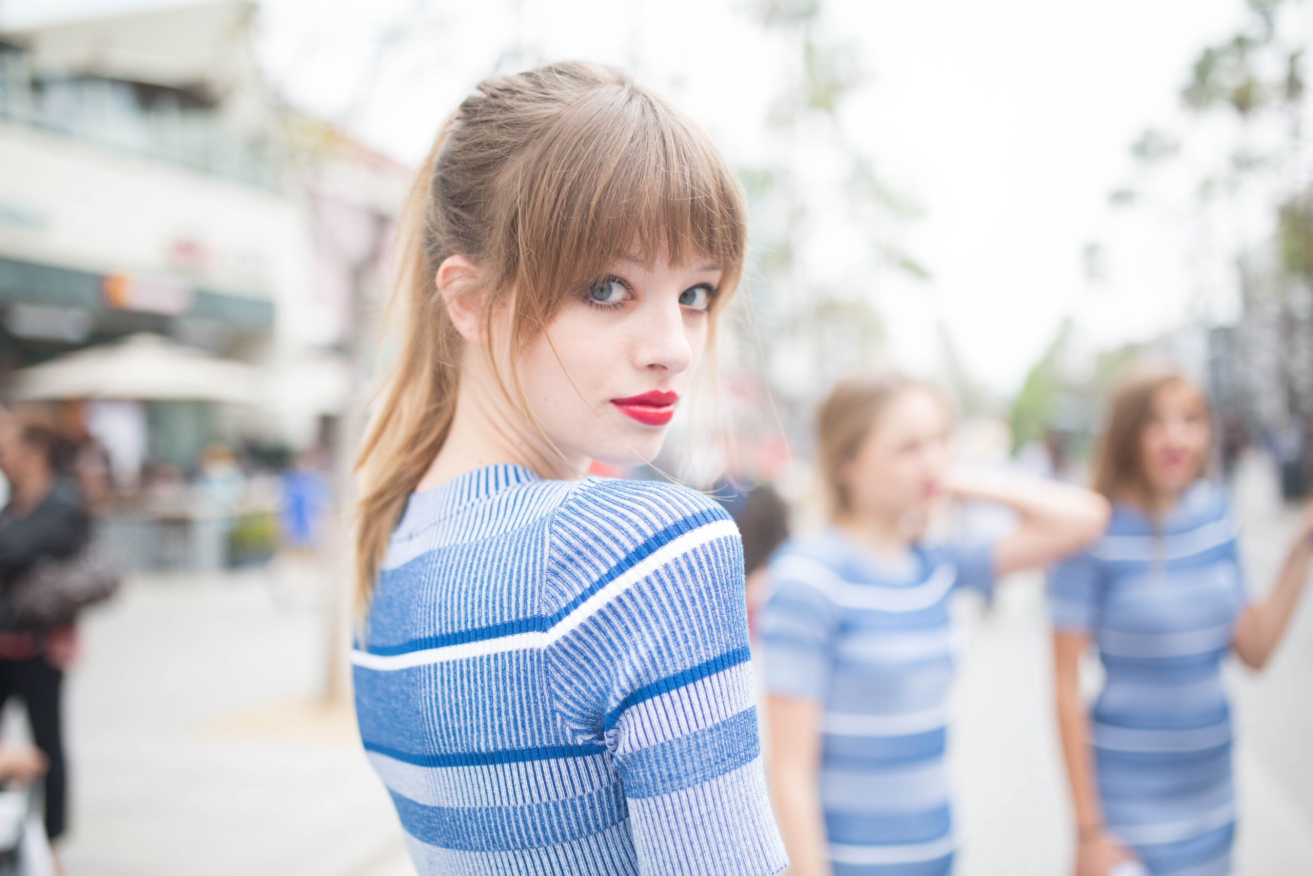 a person with red lipstick and blue striped shirt