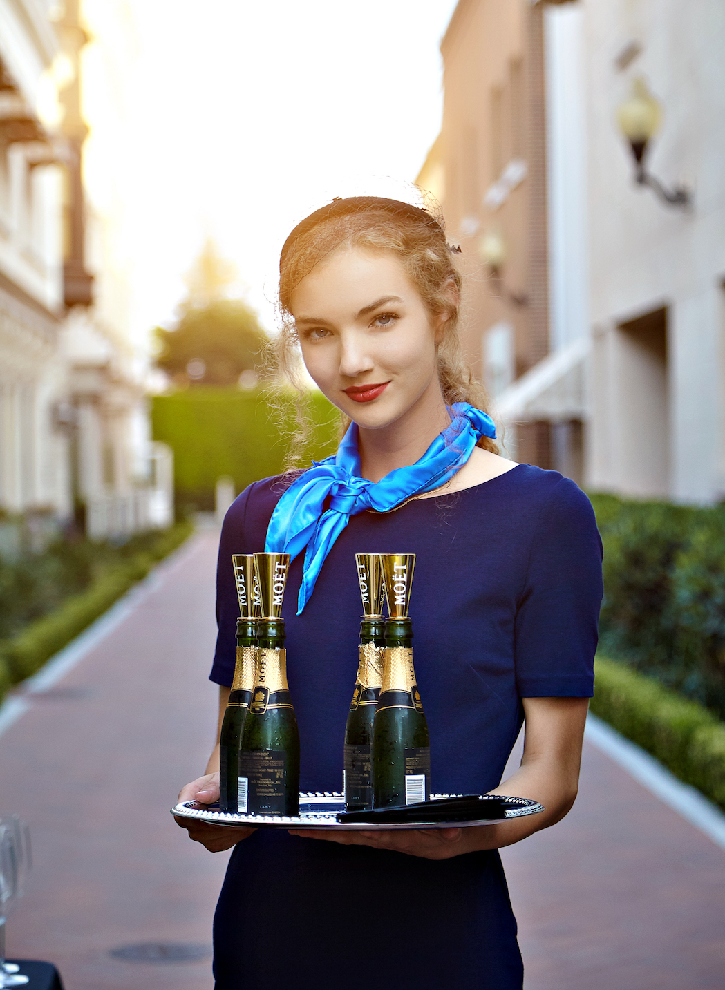 a person holding a tray of bottles